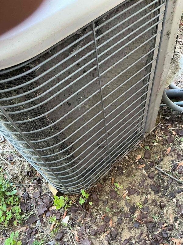 Completed comprehensive AC tune-up on 27-year-old outdoor condensing unit. System showed significant accumulation of environmental debris, dirt, and cobwebs on condenser coils and grille surfaces, consistent with age and exposure. Performed standard maintenance procedures including cleaning of condenser coils, inspection of refrigerant lines, and evaluation of overall unit operation to ensure continued functionality of aging system.