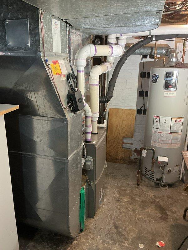 Completed installation of new air conditioning system with upflow cased coil package in basement location. Installed new line set, outdoor condensing unit on relocated metal pad positioned away from existing mini-split system, new electrical disconnect, and programmable thermostat. System tested and operational upon completion with all components properly secured and connected per manufacturer specifications.