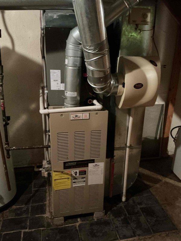 Completed routine maintenance on a 2-year-old residential air conditioning system. Performed standard tune-up procedures including inspection of the outdoor condenser unit, verification of electrical connections and disconnect functionality, and evaluation of the indoor Lennox furnace system with integrated humidifier. All components found operating within normal parameters with no immediate service needs identified.