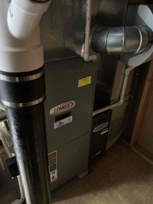 Completed comprehensive air conditioning tune-up service on residential Lennox HVAC system following rescheduled appointment due to temperature conditions. Performed standard preventive maintenance procedures on outdoor condensing unit and indoor furnace/air handler, inspected electrical connections and disconnect components, and verified proper system operation with photographic documentation of equipment condition.