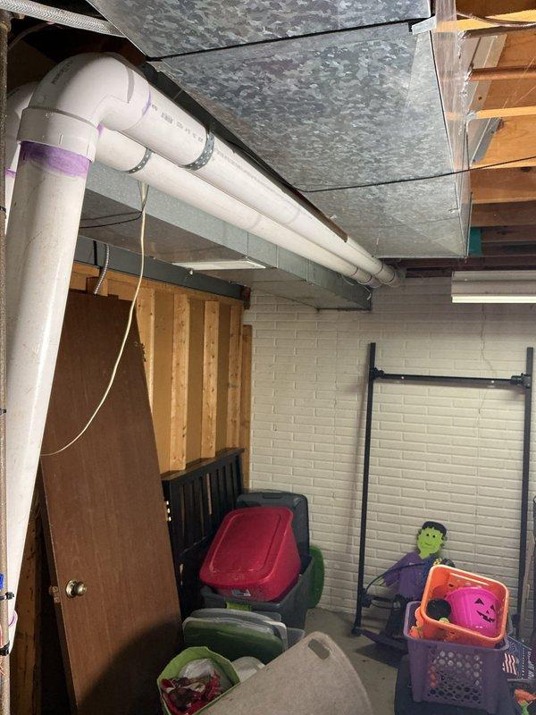 Completed full HVAC system replacement installing a Lennox 13 SEER 3.5 ton split gas system with 96% efficiency 90KBTU upflow furnace in basement utility area. Installation included new upflow cased coil, 7/8" x 30' refrigerant line set, 13 SEER condensing unit mounted on new exterior pad with disconnect box, replacement venting system, 120V condensate pump, and WiFi-enabled thermostat for remote system control. All electrical connections, conduit routing, and PVC drainage lines were properly installed per manufacturer specifications, with the outdoor unit positioned on concrete pad adjacent to home exterior with complete refrigerant line and electrical service connections.
