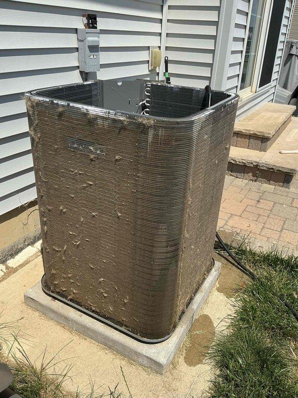 Responded to no-cooling call on 1-2 year old air conditioning system. Upon arrival, found outdoor condensing unit heavily covered in dirt, dust, and debris accumulation, restricting airflow through exterior coil surfaces. Inspected electrical connections and verified unit would not start due to excessive buildup affecting proper operation. Thoroughly cleaned condenser coil and exterior surfaces, removing environmental debris that had accumulated on cabinet and coil fins. Restored power to unit, verified compressor and fan motor operation, and confirmed system returned to normal cooling function. Unit now operating properly with adequate airflow restored.
