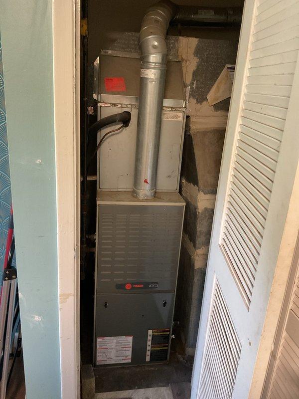 Conducted comprehensive assessment of existing HVAC system for replacement estimate. Evaluated indoor furnace and air handler unit located in utility closet, noting current vertical configuration and space constraints. Inspected outdoor Rheem condenser unit on concrete pad, documenting equipment age, condition, and installation setup. Photographed both indoor and outdoor components to provide detailed documentation for replacement equipment specifications and installation planning.