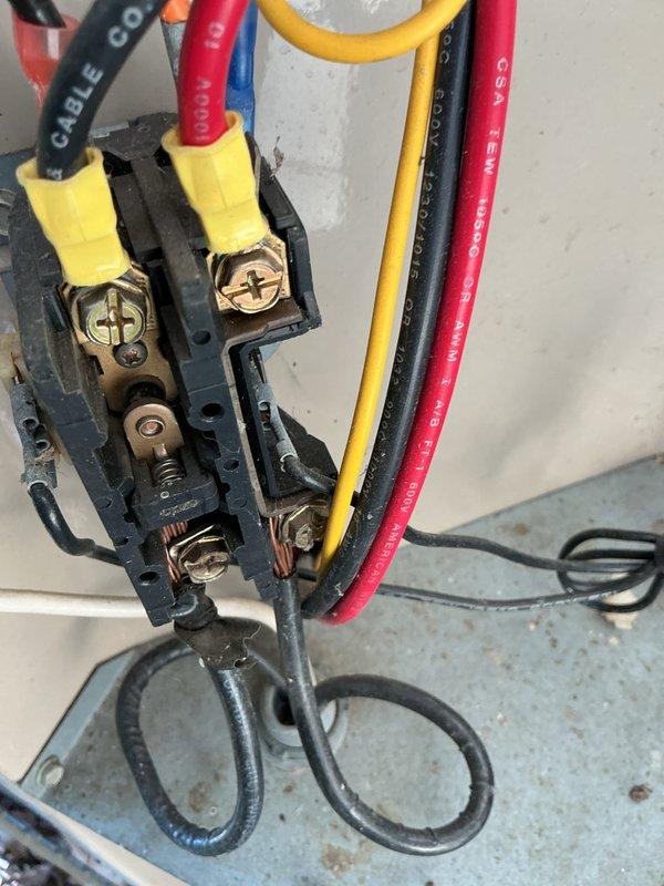 Completed 24-year-old air conditioning maintenance tune-up, inspecting electrical connections at terminal block and verifying proper wire terminations with all conductors securely fastened. Performed amperage draw measurements using clamp meter on system components, confirming unit operating within manufacturer specifications.