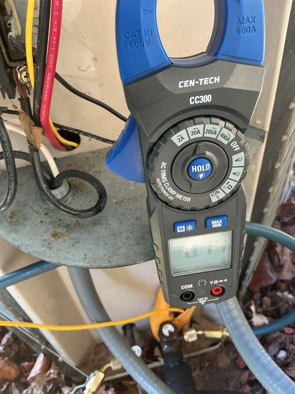 Completed 24-year-old air conditioning maintenance tune-up, inspecting electrical connections at terminal block and verifying proper wire terminations with all conductors securely fastened. Performed amperage draw measurements using clamp meter on system components, confirming unit operating within manufacturer specifications.