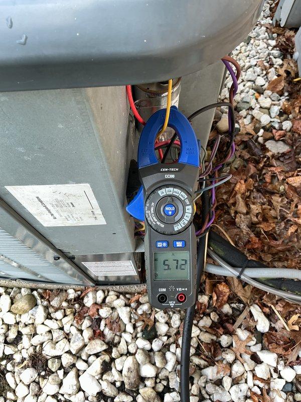 Completed comprehensive cooling maintenance on 13-year-old air conditioning system. Performed electrical diagnostics using clamp meter, recording amperage readings of 5.72 amps at the outdoor unit's electrical connection panel. Inspected control board and wiring connections inside equipment compartment, verifying proper operation of all electrical components and wire terminations across multiple circuits including power, control, and communication wiring.