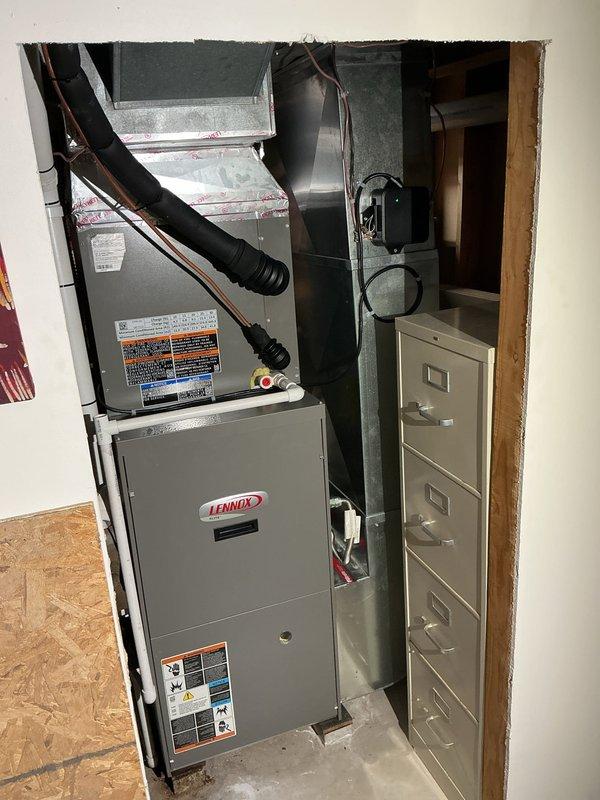 Completed installation of new air conditioning system including evaporator coil and condensing unit. Installed new refrigerant lineset and relocated outdoor condensing unit to customer's preferred location on concrete pad, positioned approximately 3 feet from electrical meter. The Lennox furnace and air handler were integrated with the new coil in the interior mechanical closet, with proper ductwork connections established. Outdoor condensing unit was mounted on rubber isolation pads with electrical disconnect and refrigerant lines properly routed along exterior wall. All electrical connections were completed per code requirements, and system was tested for proper operation upon completion.