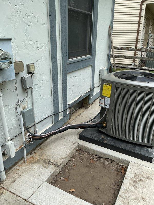 Completed installation of new air conditioning system including evaporator coil and condensing unit. Installed new refrigerant lineset and relocated outdoor condensing unit to customer's preferred location on concrete pad, positioned approximately 3 feet from electrical meter. The Lennox furnace and air handler were integrated with the new coil in the interior mechanical closet, with proper ductwork connections established. Outdoor condensing unit was mounted on rubber isolation pads with electrical disconnect and refrigerant lines properly routed along exterior wall. All electrical connections were completed per code requirements, and system was tested for proper operation upon completion.