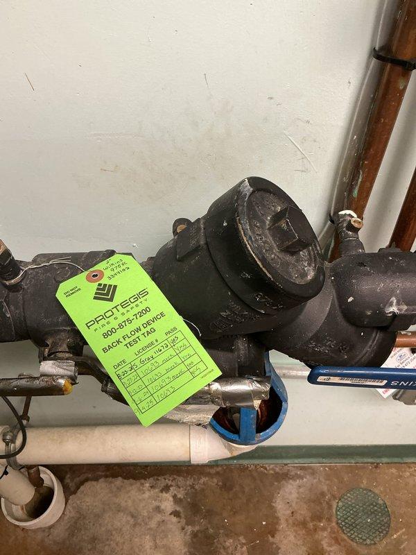Responded to service call for water on floor beneath air conditioning system. Upon arrival, found significant water accumulation on concrete basement floor around HVAC equipment area. Inspected condensate drain system and backflow preventer assembly. Identified clogged condensate drain line as source of water overflow. Cleared blockage from drain line, verified proper drainage flow, and confirmed backflow device operational. Cleaned up standing water and monitored system to ensure proper condensate evacuation restored.