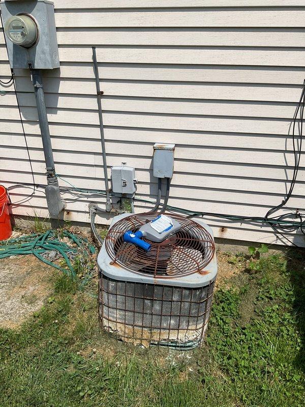 Completed comprehensive HVAC system replacement estimate for residential property to match competitor pricing from A1. Evaluated existing outdoor condensing unit with cylindrical cage housing and indoor furnace system located in basement utility area. Both units showed significant age and wear, with basement mechanical room displaying moisture concerns on surrounding concrete surfaces. Documented current equipment configuration including electrical disconnects, meter placement, conduit routing, and existing concrete pad condition for outdoor unit. Assessed ductwork connections and copper refrigerant line routing for replacement planning. Provided detailed photographic documentation of existing equipment placement, electrical service components, and installation conditions to prepare accurate material and labor specifications for complete system changeout.