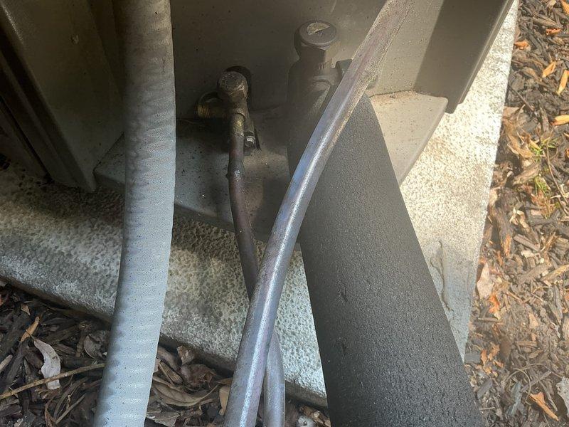Responded to no cooling complaint on 2-year-old system. Unit was running but not producing cool air. Upon arrival, performed diagnostic evaluation of outdoor condensing unit. Found system low on refrigerant charge. Connected recovery equipment and gauges to assess refrigerant levels and system pressures. Identified refrigerant loss requiring recovery and recharge. Recovered remaining refrigerant using recovery tank, inspected refrigerant lines and connections for potential leak points. System required proper refrigerant charge restoration to resume normal cooling operation.
