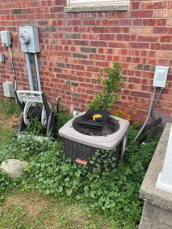 Conducted comprehensive assessment of existing HVAC system for complete replacement estimate. Evaluated outdoor Goodman condenser unit with overgrown vegetation requiring clearance, electrical disconnect, and associated conduit routing. Inspected indoor Goodman furnace installation in basement utility area, including supply and return ductwork configuration with insulated plenum connections. Documented current equipment specifications, electrical service connections, and spatial constraints for proposed system replacement. Provided detailed estimate for complete AC system replacement including equipment removal, new unit installation, and necessary electrical modifications.