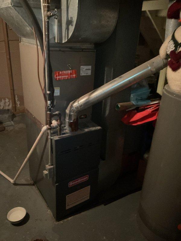 Conducted comprehensive assessment of existing HVAC system for complete replacement estimate. Evaluated outdoor Goodman condenser unit with overgrown vegetation requiring clearance, electrical disconnect, and associated conduit routing. Inspected indoor Goodman furnace installation in basement utility area, including supply and return ductwork configuration with insulated plenum connections. Documented current equipment specifications, electrical service connections, and spatial constraints for proposed system replacement. Provided detailed estimate for complete AC system replacement including equipment removal, new unit installation, and necessary electrical modifications.