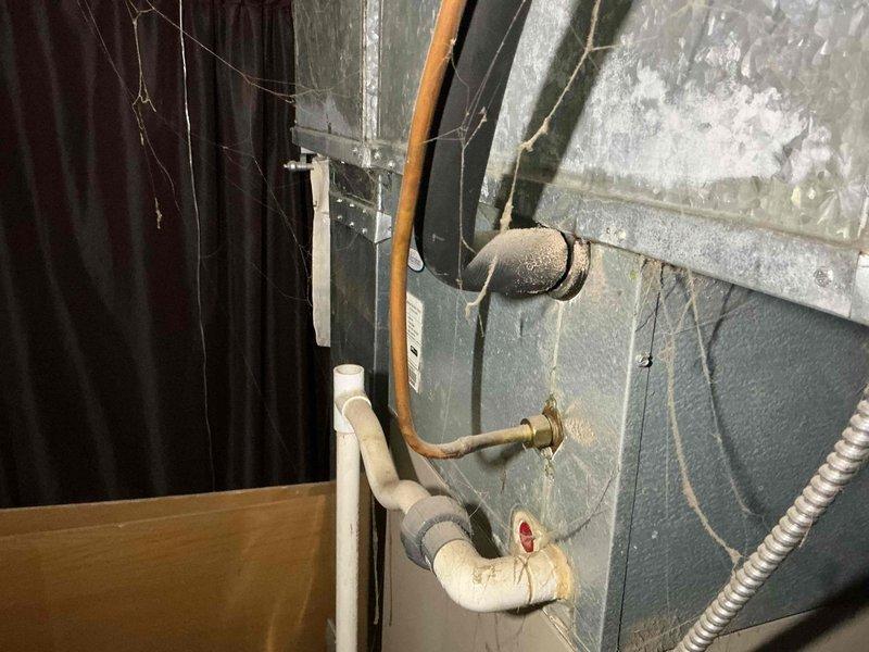 Responded to no cooling call on 5-year-old residential air conditioning system. Upon arrival, performed visual inspection of outdoor condenser unit and indoor air handler. Condenser showed significant dirt accumulation and weathering on exterior surfaces, though unit appeared structurally sound. Verified refrigerant line connections and electrical conduit at outdoor unit were intact. Inspected indoor air handler cabinet and associated copper refrigerant piping with brass service valves. System required diagnostic evaluation to determine cause of cooling failure.