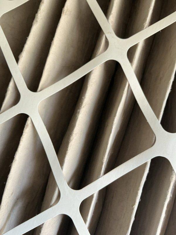 Responded to service call for 9-year-old central air conditioning system with complaint of faint cold air output. Upon inspection, discovered severely clogged air filter with significant dust and debris accumulation restricting airflow throughout the system. Replaced dirty air filter with new unit, restoring proper airflow and system performance. System tested and confirmed operating within normal parameters with adequate cooling output.