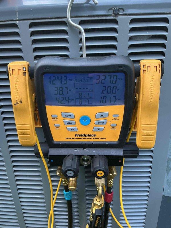 Responded to no cooling complaint on 3-year-old Amana air conditioning system. Upon arrival, connected Fieldpiece SMAN digital manifold gauges to service ports to diagnose refrigerant pressures and system temperatures. Performed system diagnostics and pressure testing to identify cause of cooling failure. Unit evaluated for warranty coverage eligibility given age of equipment.