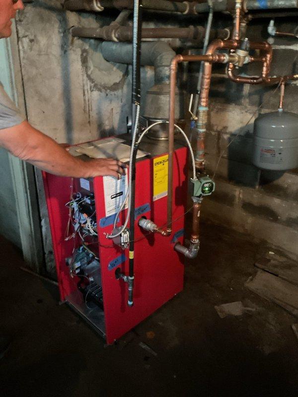 Responded to service call for boiler system evaluation. Upon arrival, assessed existing boiler installation that was previously completed by another contractor. Inspection revealed the system was not installed properly according to code requirements. Documented extensive copper piping configuration, expansion tank mounting, and red boiler unit connections with pressure gauges and valving system. Coordinated scheduling availability and provided estimate for proper reinstallation work. Customer acknowledged that permit will be required for corrective installation to bring system into compliance with local building codes and manufacturer specifications.
