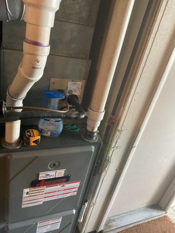 Completed comprehensive estimate for residential air conditioning system replacement. Evaluated existing Amana furnace installation in utility area, assessed current HVAC infrastructure including ductwork, PVC condensate drainage, refrigerant lines, and ventilation components. Documented system configuration and surrounding installation space to provide accurate replacement recommendations and equipment specifications for new AC unit installation.