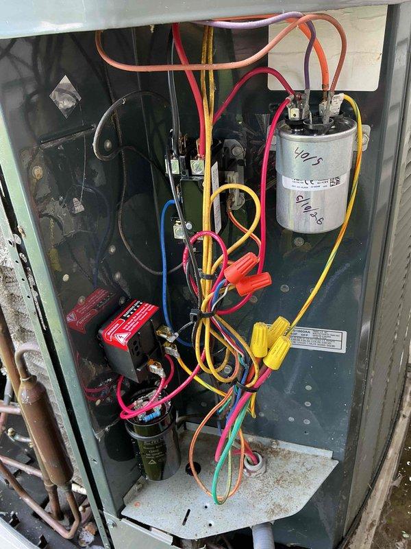 Responded to no cooling complaint on 14-year-old air conditioning system. Upon inspection, found failed dual-run capacitor causing compressor to hard-start and produce abnormal noise. Replaced defective capacitor with properly rated unit, verified all electrical connections, and tested system operation. Unit now cooling properly with compressor running quietly and efficiently.