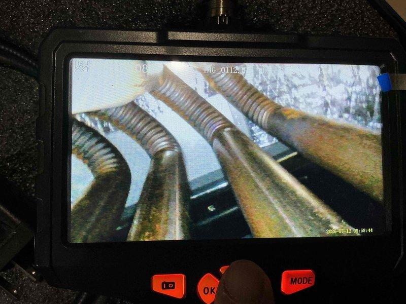 Completed comprehensive spring maintenance inspection on HVAC cooling system. Performed detailed internal component examination using borescope camera to assess evaporator coil condition, revealing moderate dirt accumulation and minor oxidation on metallic fins with visible discoloration on copper refrigerant lines. Inspected ductwork system and flexible duct connections, noting dust buildup on surfaces and insulation areas that will require monitoring during future maintenance cycles.