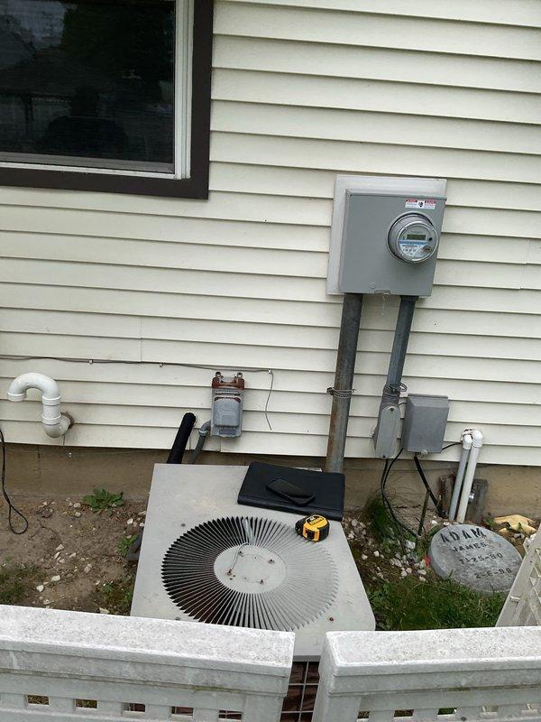 Conducted comprehensive assessment of existing HVAC system for complete furnace and air conditioning replacement. Evaluated current outdoor condensing unit mounted on exterior foundation alongside electrical meter and service disconnect, noting equipment age and operational condition. Inspected indoor furnace installation in mechanical room, including existing ductwork configuration, humidifier integration, electrical panel connections, and PVC condensate drainage system. Documented equipment specifications, clearances, and utility connections to provide accurate replacement estimate for new heating and cooling system.