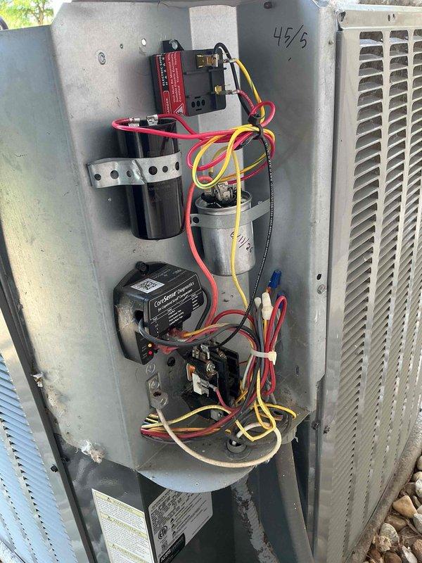 Responded to no cooling call at commercial salon location. Upon arrival, found air conditioning system not providing cooling to entire facility. Performed diagnostic evaluation of outdoor condensing unit. Removed access panel and inspected electrical components including dual run capacitor, contactor, and associated wiring connections. Tested capacitor for proper microfarad readings and voltage. Verified all wire terminations were secure at capacitor terminals and contactor. Checked contactor operation and coil functionality. Inspected control board and relay components for proper operation. All electrical connections tested and found to be within manufacturer specifications. System cycled properly during testing phase. Completed routine maintenance service while on site, including cleaning condenser coil, checking refrigerant pressures, and verifying proper amperage draw on compressor and fan motor. System restored to normal cooling operation. Left unit operational with all access pan