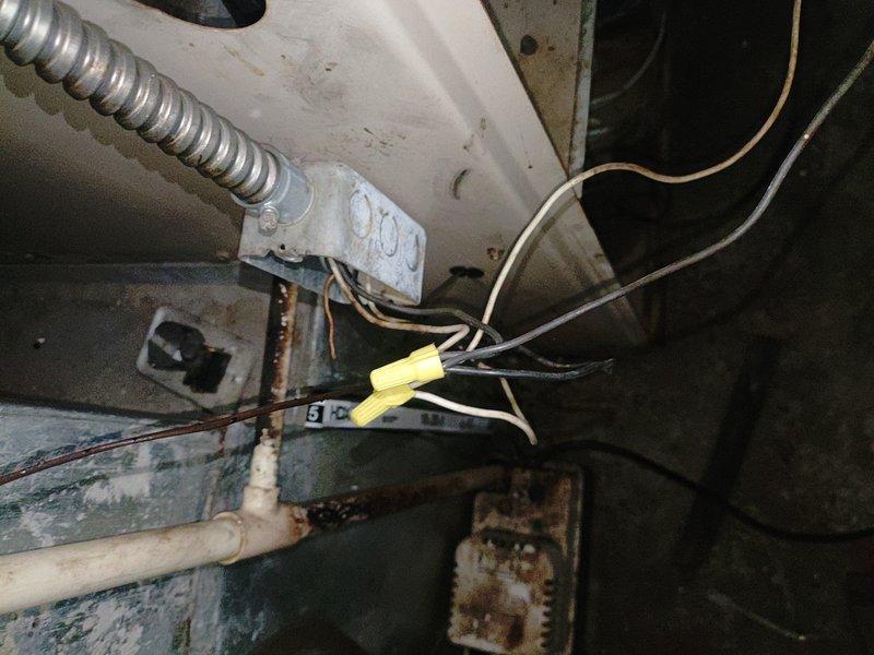 Responded to service call for two non-operational air conditioning units following a power surge. Upon inspection, confirmed electrical damage to control boards on both systems, with visible signs of power surge impact including compromised wiring connections and corroded electrical components. Assessed extensive deterioration throughout both units, including significant rust on metal components, mold growth on surfaces, and moisture damage indicating prolonged exposure and deferred maintenance. Documented electrical connection points showing yellow wire connectors at junction areas, corroded metal brackets, and compromised housing panels. Verified electrician's preliminary assessment and provided professional HVAC evaluation confirming control board failure on both units requiring replacement to restore operation.