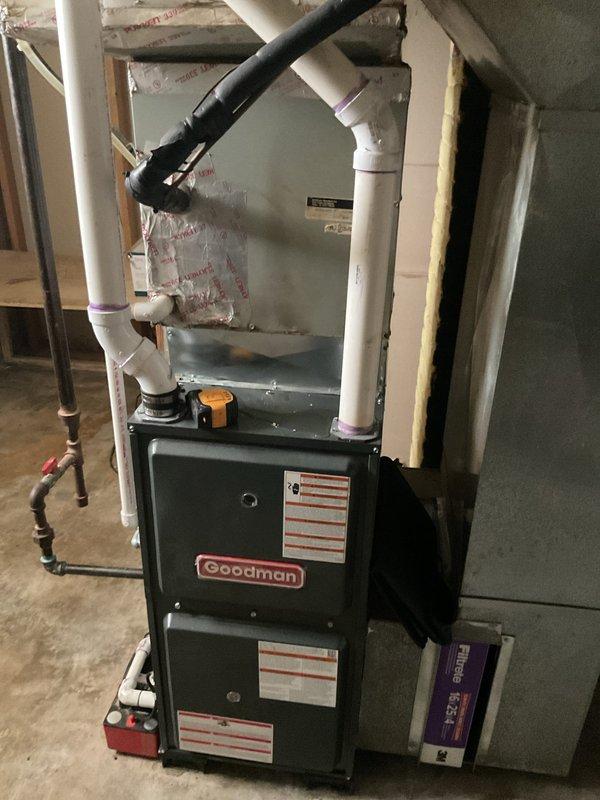 Conducted comprehensive evaluation of existing HVAC system for equipment replacement estimate. Assessed Goodman furnace unit located in basement utility area, documenting current installation configuration including PVC venting system, flexible ductwork connections, and electrical components. Inspected outdoor condensing unit positioned on concrete pad adjacent to home foundation, evaluating overall condition and operational status. Performed diagnostic testing of exterior AC unit to determine system performance and identify replacement requirements. Documented existing equipment specifications, installation layout, electrical disconnect configuration, and condensate drainage system. Captured detailed photographic documentation of both indoor and outdoor components to support replacement proposal and equipment sizing recommendations.