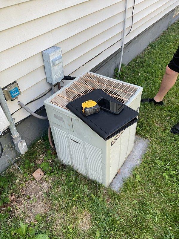 Conducted comprehensive evaluation of existing HVAC system for equipment replacement estimate. Assessed Goodman furnace unit located in basement utility area, documenting current installation configuration including PVC venting system, flexible ductwork connections, and electrical components. Inspected outdoor condensing unit positioned on concrete pad adjacent to home foundation, evaluating overall condition and operational status. Performed diagnostic testing of exterior AC unit to determine system performance and identify replacement requirements. Documented existing equipment specifications, installation layout, electrical disconnect configuration, and condensate drainage system. Captured detailed photographic documentation of both indoor and outdoor components to support replacement proposal and equipment sizing recommendations.