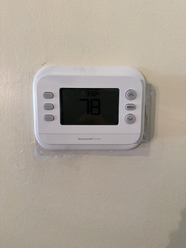 Completed full HVAC system installation including outdoor condensing unit and indoor evaporator coil package with necessary ductwork modifications to accommodate equipment. Installed new concrete pad for outdoor unit, flushed existing line set, and replaced electrical disconnect and whip connections. Installed two Honeywell Home digital thermostats and configured refrigerant service valves with proper safety labeling, resolving component failure from previous maintenance visit.