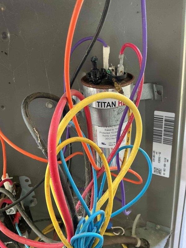 Responded to no cooling call on 15-year-old residential HVAC unit. Upon inspection, found failed dual run capacitor preventing compressor and condenser fan motor operation. Verified electrical connections and tested amperage draw, which measured 8.55 amps on compressor circuit. Replaced defective TITAN HD capacitor with proper microfarad-rated replacement, restored all wire connections, and confirmed system returned to normal cooling operation with proper amp draw.