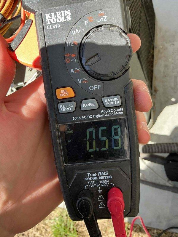 Responded to no cooling complaint on 8-9 year old residential air conditioning system. Upon arrival, performed comprehensive AC tune-up and diagnostic evaluation including electrical measurements and visual inspection of outdoor condensing unit. System found operating within normal parameters with proper amperage draw of 0.59A recorded on compressor circuit. Completed routine maintenance procedures, verified proper operation of all components, and confirmed unit cooling effectively with no issues present at time of service.