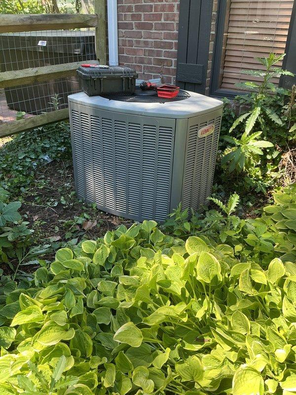 Performed leak search on residential Lennox air conditioning system. Accessed compressor and electrical components by removing service panel to inspect refrigerant lines, connections, and compressor assembly for potential refrigerant leaks. Documented equipment condition with photos for service records.