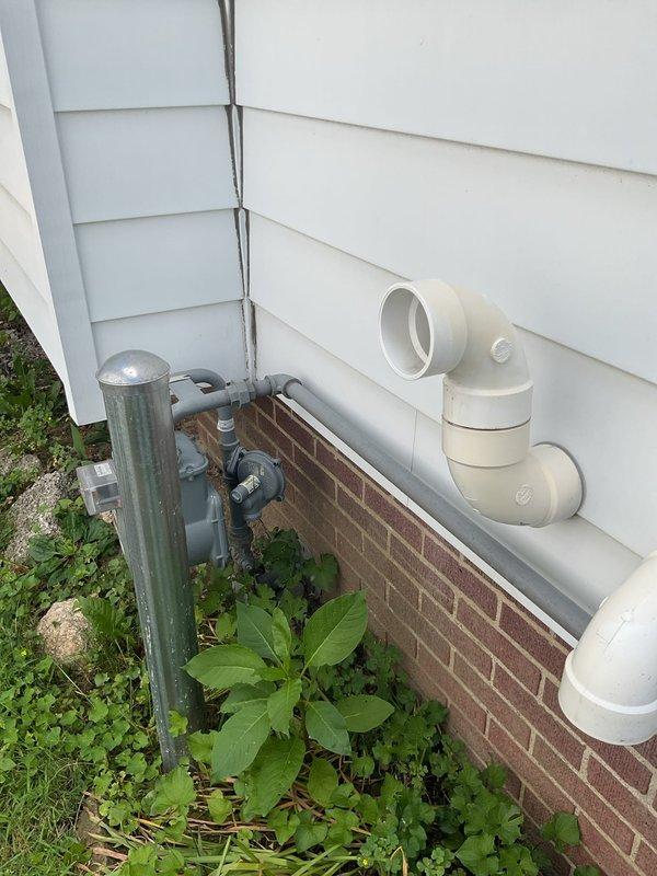 Conducted site evaluation for gas line extension from existing meter to garage and furnace location. Assessed current gas meter placement on exterior brick foundation and identified routing path for new gas piping installation. Documented existing utility configurations including electrical conduit and PVC drainage systems to ensure proper clearances and code-compliant installation planning for the proposed gas line run.