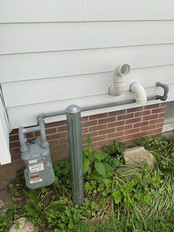 Conducted site evaluation for gas line extension from existing meter to garage and furnace location. Assessed current gas meter placement on exterior brick foundation and identified routing path for new gas piping installation. Documented existing utility configurations including electrical conduit and PVC drainage systems to ensure proper clearances and code-compliant installation planning for the proposed gas line run.