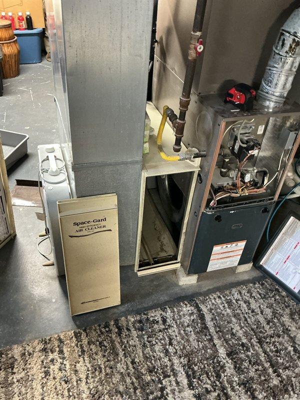 Responded to no cooling call on 7-year-old residential air conditioning system. Upon arrival, found outdoor condensing unit fan motor inoperative with evidence of electrical failure following homeowner's attempt to clean debris from unit. Diagnosed failed condenser fan motor with burnt windings, causing the reported burning smell. Replaced condenser fan motor and capacitor, verified proper electrical connections, tested system operation, and confirmed adequate airflow and cooling performance. System restored to normal operation with proper temperature differential across evaporator coil.
