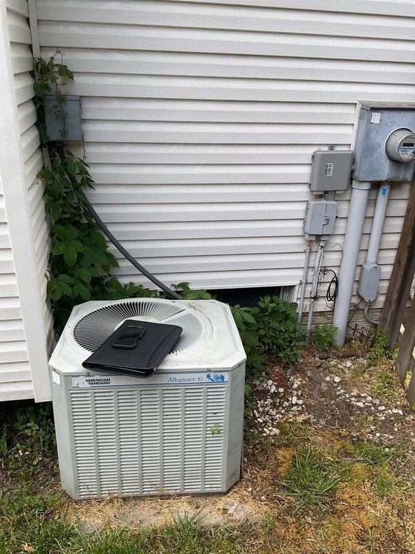 Conducted comprehensive site evaluation for complete HVAC system replacement at residential property. Assessed existing American Standard outdoor condensing unit with associated electrical disconnect and metering equipment mounted on exterior wall. Evaluated indoor air handler system located in basement utility area, including furnace unit with existing ductwork, PVC condensate drainage lines, and electrical connections. Documented current equipment specifications, installation configuration, and all necessary measurements to provide accurate replacement estimate for new AC system installation.