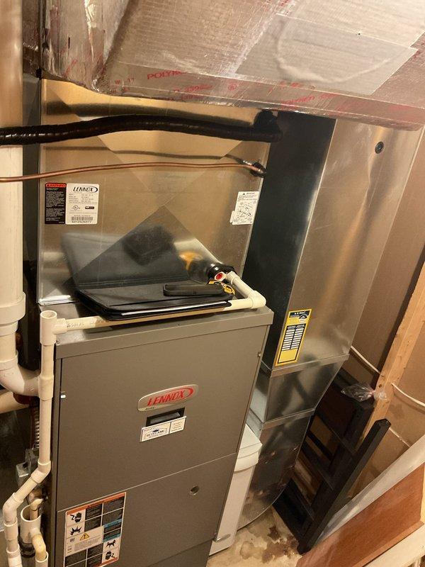 Conducted comprehensive assessment of existing Lennox HVAC system for complete air conditioning replacement. Evaluated current indoor furnace and evaporator coil assembly located in basement mechanical room, noting configuration with existing condensate drainage and refrigerant line routing. Inspected outdoor condenser unit positioned on concrete pad against exterior brick wall, assessing clearances and landscaping considerations for replacement installation. Documented system specifications, electrical requirements, and existing infrastructure including PVC condensate piping and refrigerant line sets. Provided detailed estimate for new air conditioning system replacement including indoor and outdoor components, ensuring proper sizing and compatibility with existing ductwork and electrical service.