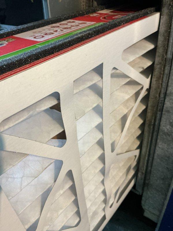 Responded to service call for air conditioning system struggling to maintain 74°F setpoint and running continuously. System includes 9-year-old furnace and recently replaced outdoor condensing unit following storm damage. Upon inspection, discovered severely restricted airflow due to improperly installed or undersized air filters in dual filter rack system. Filters showed inadequate sealing with visible gaps around foam gasket material, allowing bypass airflow and reducing system efficiency. Evaluated damper control mechanism in ductwork, noting accumulated debris and potential calibration issues affecting zone control or airflow distribution. Corrected filter installation to ensure proper sealing and airflow capacity. Assessed overall system operation and provided recommendations for follow-up evaluation of outdoor unit installation quality, refrigerant charge verification, and ductwork balancing to resolve ongoing cooling deficiency issues.