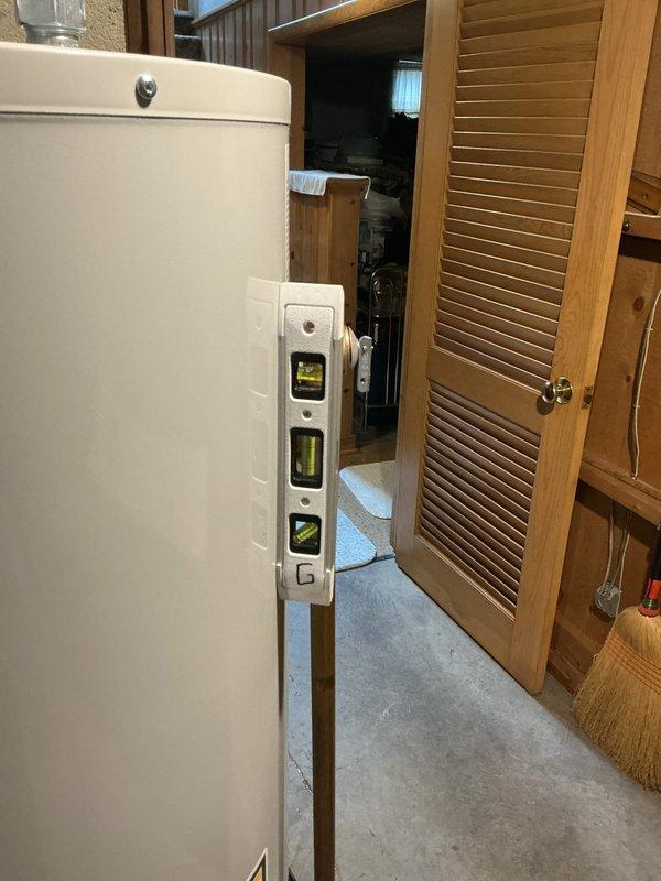 Replaced existing 40-gallon standard water heater in basement utility area. Disconnected old unit, installed new white cylindrical tank water heater with proper plumbing connections including copper piping, brass fittings, yellow-handled shut-off valve, and pressure relief valve assembly. Connected gas control valve assembly at base of unit with appropriate wiring. Verified unit was level and secure on concrete floor. Tested all connections for proper operation and ensured compliance with safety standards.