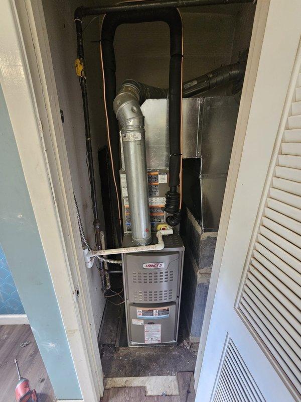 Completed full HVAC system installation including a Lennox 70,000 BTU 80% efficiency upflow furnace with cased evaporator coil installed in interior closet space. Fabricated and installed 1-inch filter rack lift box to accommodate proper filtration access. Installed new refrigerant lineset with insulation connecting indoor and outdoor units, secured along exterior siding and routed through closet space. Set 13 SEER outdoor condensing unit on new concrete equipment pad adjacent to home exterior with proper clearances. Installed electrical disconnect and whip for outdoor unit per code requirements. Relocated and installed new programmable thermostat near return air location for improved system control and accessibility. All ductwork connections, exhaust venting, and refrigerant lines completed with proper sealing and insulation. System tested, charged to manufacturer specifications, and verified operational.
