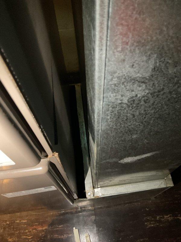 Conducted comprehensive assessment of existing HVAC system for complete replacement estimate. Evaluated outdoor condensing unit installed on platform base against exterior brick wall, documenting current electrical connections, conduit routing, and wall-mounted disconnect components. Inspected indoor air handler installation, examining sheet metal ductwork connections, support framing, refrigerant line routing, and insulation condition. Photographed both outdoor and indoor equipment to document existing system configuration and provide detailed specifications for proposed AC and air handler replacement.