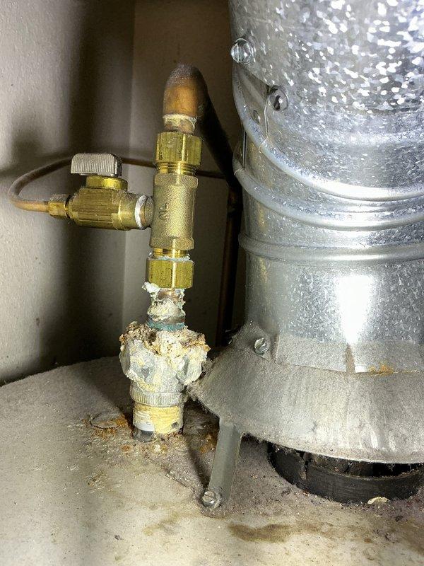 Completed annual maintenance on 27+ year old air conditioning system. Performed standard tune-up procedures including inspection of water heater components showing significant mineral buildup on brass fittings and pressure relief valve, and conducted ductwork inspection using diagnostic camera to assess interior conditions of ventilation system.