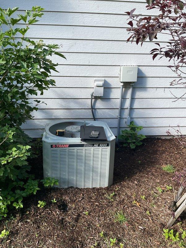 Conducted comprehensive assessment of existing HVAC system for full replacement estimate. Evaluated outdoor Trane XE 1000 condensing unit positioned against home exterior, noting current electrical disconnect configuration and conduit routing up siding. Documented indoor equipment including Carrier furnace, existing ductwork with flexible insulation, and air handler unit in basement utility area. Photographed all major components, electrical connections, and spatial constraints to provide accurate replacement specifications. Customer provided with detailed estimate for complete system replacement including new outdoor condensing unit, indoor air handler, and necessary electrical modifications to meet current code requirements.