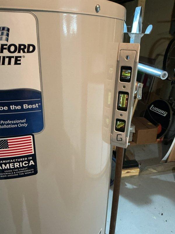 Conducted on-site assessment of non-functional Bradford White water heater in residential basement utility room of 1970s-era home. Documented existing installation configuration including copper supply piping, gas line connections, flexible metal conduit, exhaust venting with angled elbow assembly, and shut-off valve locations. Evaluated equipment condition, surrounding mechanical room layout with adjacent HVAC system, and existing plumbing infrastructure to provide comprehensive replacement quote for professional water heater installation.