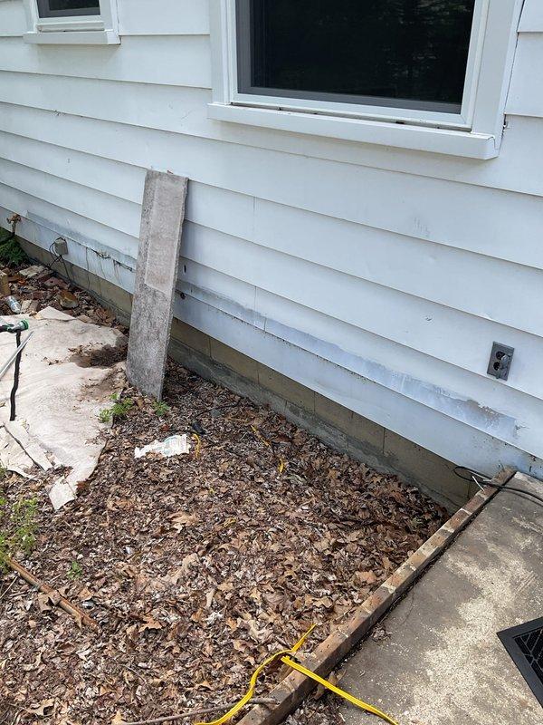 Conducted comprehensive assessment of existing HVAC system for complete replacement estimate. Evaluated current furnace unit and air conditioning system, documenting equipment age, condition, and installation configuration. Inspected exterior condenser location and clearances near foundation landscaping area, noting available space for new equipment placement. Assessed interior installation including existing ductwork connections, venting arrangement, and spatial requirements in basement utility area. Documented current system specifications and measured dimensions for proper equipment sizing recommendations. Provided detailed replacement options for both heating and cooling components based on home's requirements and existing infrastructure.