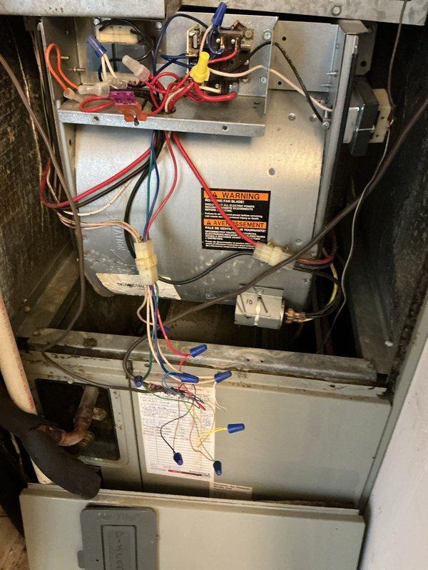 Responded to no cooling call on 27-year-old all-electric HVAC system where neither heating nor air conditioning would activate. Upon arrival, inspected thermostat wiring and connections at wall-mounted control, noting previous replacement approximately six months prior that had not functioned properly since installation. Examined air handler unit in basement, documenting internal wiring configuration and low voltage circuit connections. Initial troubleshooting revealed potential issues with low voltage control circuit requiring further diagnosis. Scheduled follow-up appointment to complete comprehensive low voltage circuit troubleshooting and identify root cause of system failure.