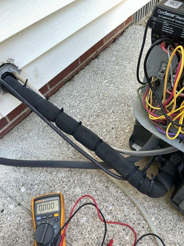 Completed scheduled air conditioning maintenance visit during early morning hours. Performed comprehensive system diagnostics using digital multimeter and CoreSense diagnostic equipment to verify electrical values and system performance on outdoor condensing unit. Inspected HVAC components, refrigerant line sets with insulation, and electrical connections at exterior utility panel. All system parameters tested within normal operating range, and unit confirmed to be functioning properly for the cooling season.
