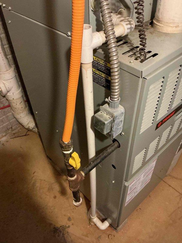 Responded to no cooling call and diagnosed failed compressor in outdoor condensing unit. Inspected electrical components including contactor and capacitor, documented system condition with photos showing weathered outdoor unit housing and interior basement HVAC installation. Provided estimate for compressor replacement to restore cooling operation.