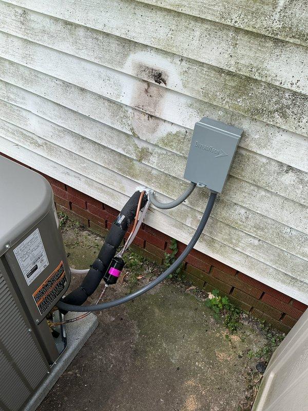 Completed full HVAC system installation including outdoor condensing unit and indoor upflow cased coil package. Installed new 3/4" x 30' refrigerant line set connecting outdoor and indoor components. Positioned condensing unit on new concrete equipment pad at exterior foundation. Mounted new electrical disconnect box on building exterior with appropriate conduit and whip assembly for power connection. Installed new thermostat for system control. All refrigerant lines properly insulated and secured, electrical connections completed per code requirements, and system tested for proper operation upon completion.